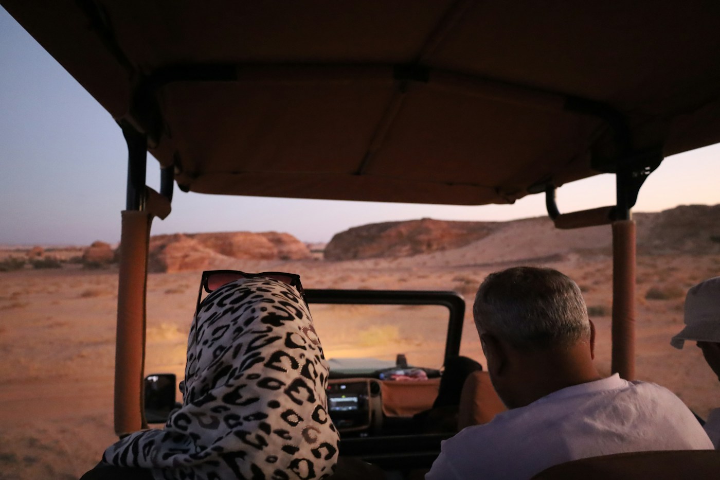 Travelers exploring the AlUla desert in an open safari vehicle