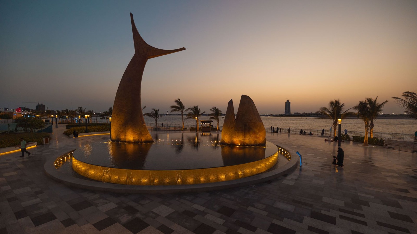 A fish sculpture, palms and a visitor promenade at Obhur in Jeddah