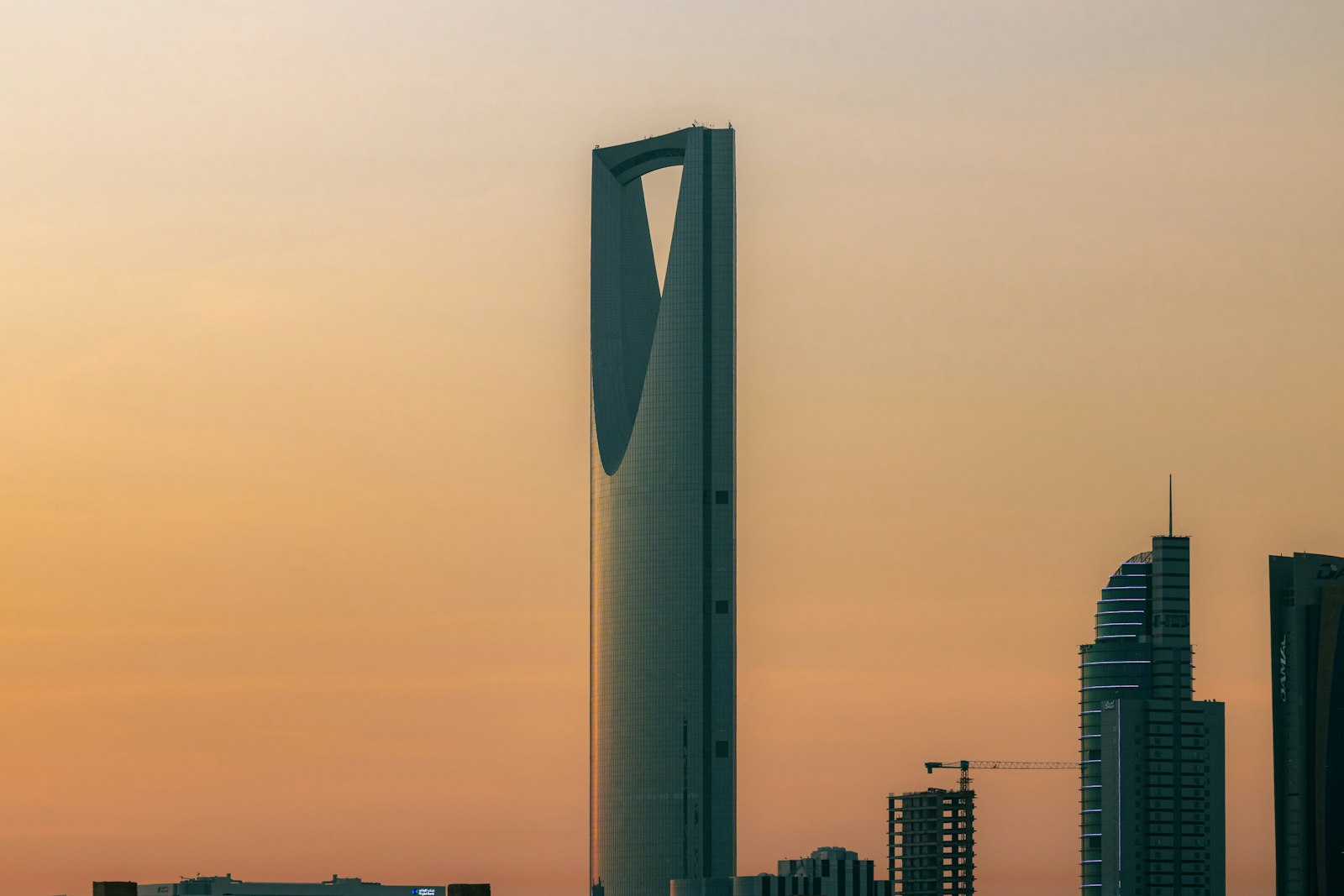 The Kingdom Centre tower against an orange sky