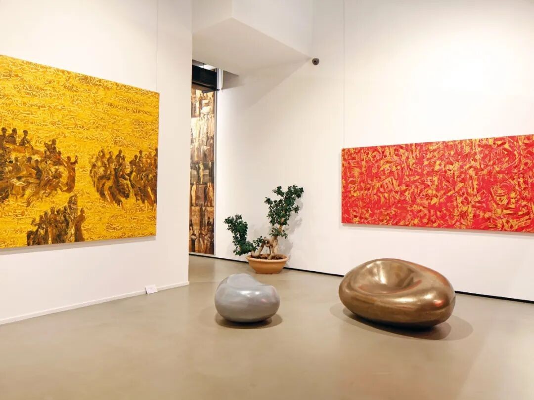 A reference exhibition room at Naila Art Gallery with paintings and sculptural seating